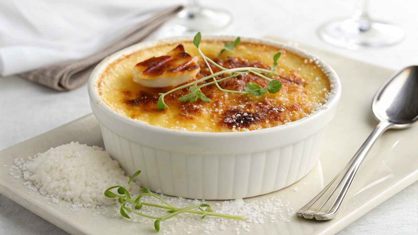 Crab Brûlée Served In An Elegant White Ramekin.